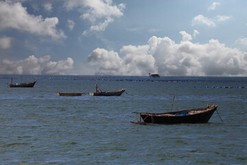 A fishing boat floats in the middle of the sea..