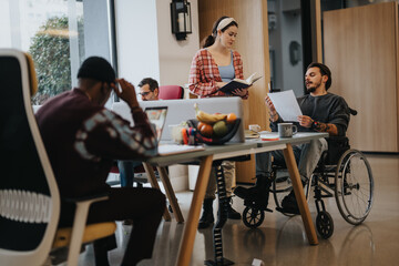 Diverse group of professionals working in a modern office setting, showcasing inclusion with a...