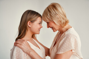 Mom and daughter isolated on background