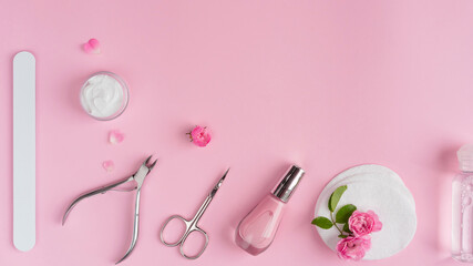 Obraz na płótnie Canvas Salon manicure concept photo. Manicure equipment with nail polish and rose petals pink background top view space for text
