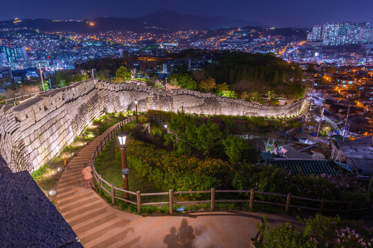 Korean cityscape at night at Naksan Park with Ancient Walls in Seoul, South Korea.