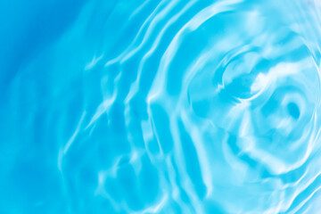 Blue water surface,Transparent blue clear water surface texture with ripples, splashes and bubbles. Abstract nature background Water waves in sunlight. Cosmetic moisturizer micellar toner emulsion. 
