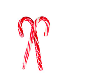 New Year's sticks candy canes with stripes on a white isolated background close-up