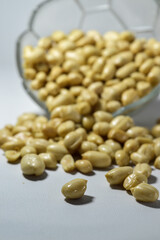 Kacang goreng or fried peanuts. Indonesian snacks. Isolated on a white background. Selective focus