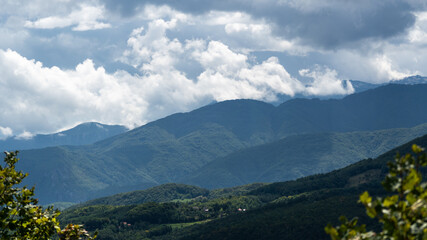 Mountain village against mountains in haze, countryside near Prozor in Bosnia and Herzegovina, mountain landscape