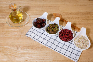 dried apricots, Many nuts, and sesame seeds on wooden background. Healthy food, snacks. Vegetarian...
