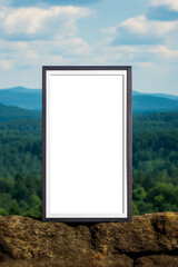 Frame mockup with transparent background on a stone wall outdoors.