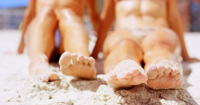 People, friends and toes playing in sand, bonding and support in nature and having fun at beach. Closeup, feet and traveling on summer holiday in outdoors, together and relaxing on tropical vacation