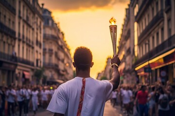 An unidentified man in a white t-shirt with a torch on the streets of Paris at sunset. Paris is the capital of the 2024 Olympic Games. Walking with the Olympic flame through the streets of Paris - obrazy, fototapety, plakaty