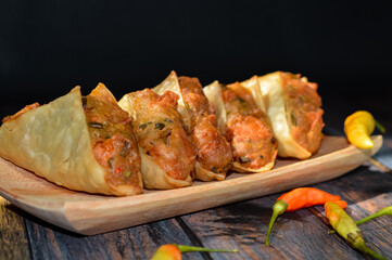 Martabak Tahu or Tofu Martabak, filled with bits of vegetables, leek, red chili, sausage, tofu and egg. Indonesian street food.