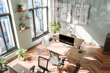 luxurious loft apartment with floor-to-ceiling windows and panoramic view; modern minimalistic interior design of workspace, top down view, home office area; bright daylight; 3D rendering