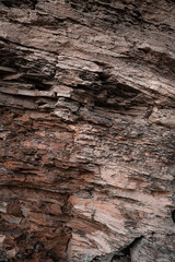 Texture natural brown stone wall vertical