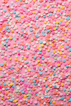 Pink pattern backgrounds with pink or blue sweets and lolipops or candies. Happy party concept.