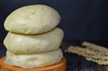 Bapao is a steamed bun with savory or sweet filling. Peanut bakpao  on wooden plate. selected focus.