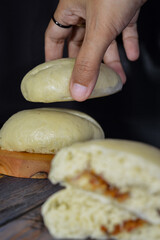 Bapao is a steamed bun with savory or sweet filling. Peanut bakpao  on wooden plate. selected focus.