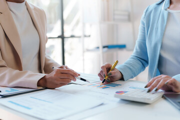 Teamwork process, business people working in the office discussing documents and ideas at meeting.