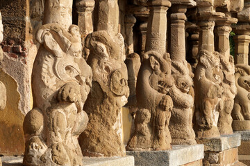 Row of pillars with carvings of Lion sculpture in in ancient Kanchi Kailasanathar temple in...