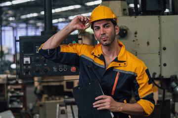 Caucasian engineer using a laptop in a factory. man working in plastics factory.