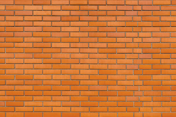 The wall is made of old red brick.