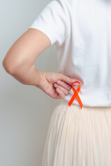 Woman having back abdomen pain with Orange ribbon. Kidney Cancer Awareness March month, disease of...