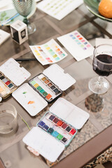 Paints and wine on a table