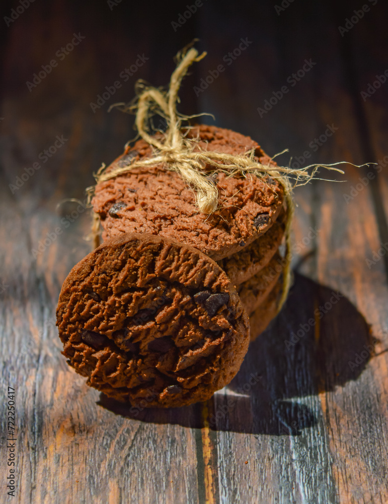 Wall mural Stack of chocolate cookies on wooden table.