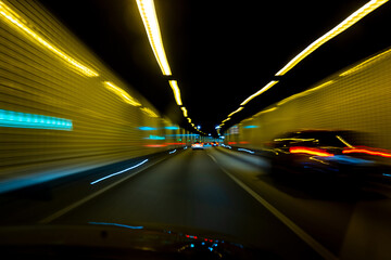 Motion. Car in tunnel. Blurred car ride. Car driving traffic. Speed riding. Car motion. Speed ride.