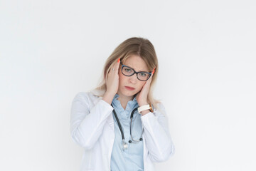 Close up portrait of tired female doctor with headache standing isolated on white background	
