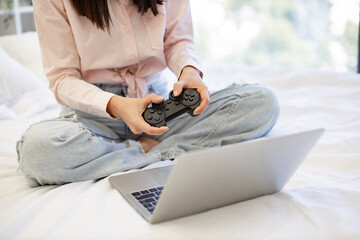 Close up view of hands of woman using modern devices enjoying favorite video game on weekend....