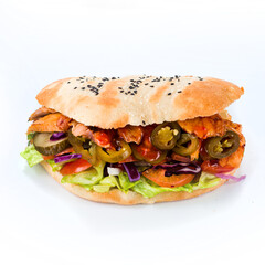 Flatbread with stuffing of fresh vegetable salad with tomatoes, chicken, pork, lettuce, cheese, pickled cucumbers, cabbage and jalapeno pepper on white background.