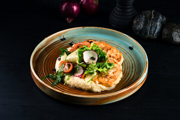 Chicken cutlets with mashed potatoes and fresh vegetable salad.