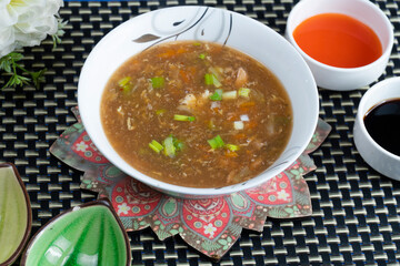 Hot and Sour Soup on textured background