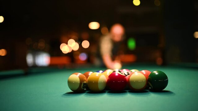 Man breaking spheres in billiard