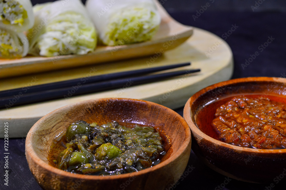 Wall mural Sawi gulung tahu or rolled Chinese cabbage with tofu. Served with red chilli sauce and green chilli sauce.