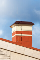 house with a roof from a red shingles with a pipe