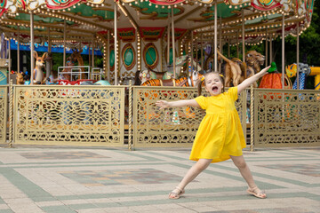 Obraz na płótnie Canvas Cute little girl having fun on a playground outdoors in summer. Little girl having fun in amusement park