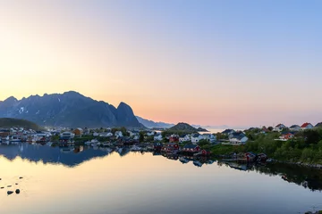 Fototapeten Tranquil summer night at Reine, Lofoten Islands, Norway, with colorful houses reflected in still waters under a soft twilight sky © Artem