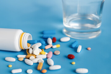 Close-up, Pills scattered on the table. Many pills of different colors and shapes