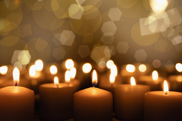 A candle burns on a dark background. Enlarged image of a candle in the dark