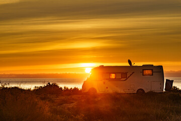 Fototapeta premium Caravan on sea at sunrise.