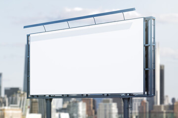 Fototapeta premium Blank white horizontal billboard on skyline background at daytime, perspective view. Mock up, advertising concept