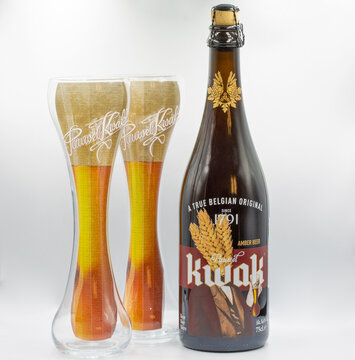 Kwak beer bottle and glasses closeup on white,