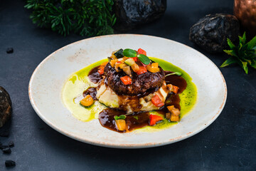 Fried beef cutlet with mashed potatoes, vegetable salad and sauce.