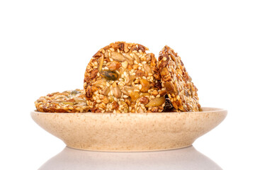 Several sweet Thaler cookies with nuts on a ceramic saucer, macro, isolated on white background.