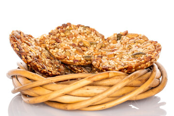 Several sweet Thaler cookies with nuts on vine saucer, macro, isolated on white background.