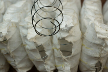 Close-up of a broken mattress with metal springs sticking out. Repair of the spring block in mattresses. Selective focus. Independent spring block is broken