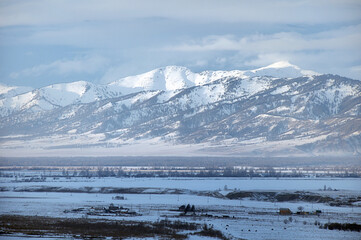 Cold snowy mountain landscape at sunset.