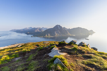 The sun's endless glow bathes the Lofoten Islands, with the view from Offersoykammen capturing the...
