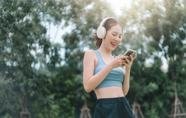 sport, fitness, woman, fit, earphones, exercise, healthy, lifestyle, music, training. sports woman listening to select music on headphones before exercise. woman in sportswear standing against the sky