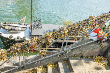 Love locks attached to stairs in Paris France on the banks of the Seine near the Eiffel Tower